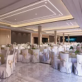 Elegant Banquet Hall Interior With Decorated Tables Chairs Floral Arrangements And Ceiling Lights