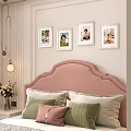 Photo Wall With Framed Photos Above Pink Headboard In Cozy Bedroom