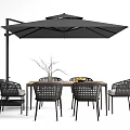 Stylish Outdoor Table with Wicker Chairs Black Umbrella and Fruit on Wooden Top