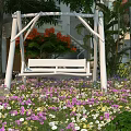 White Hanging Chair in Outdoor Garden with Colorful Flowers Tree Building Green Plants and Butterflies