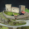 Medieval Castle Architecture With Stone Walls Towers On Green Hill And Path