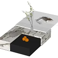 Modern Coffee Table with Marble Surface Black Drawer Vase Branches Magazine and Eggs
