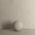 White Textured Sphere Component On Neutral Surface With Light Wall