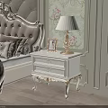 Elegant White Bedside Table With Carved Legs Gold Lamp And Photo Frame In Classic Bedroom
