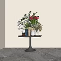 Red Tulips And White Orchids In Metal Vases On Round Table With Beige Walls