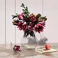 Transparent Glass Vase With Pink Red Flowers Green Leaves On Tabletop With Book And Pomegranate