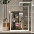 Elegant Clothing Store Window Display With Stylish Mannequin Hanging Lights And Decorative Plants