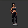 Active Woman in Blue Sports Bra Dark Leggings and White Sneakers Standing on Gray Background