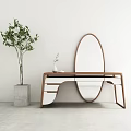 Wooden Dressing Table With Oval Mirror And Green Plant In Gray Planter Against White Wall