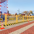 Construction Site With Yellow Safety Barriers Orange Traffic Cones Excavators And Cranes Under Blue Sky