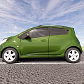 Green Compact Car Parked On Gravel Road With Blue Sky And Green Grass