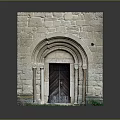 Historic Arched Stone Gate With Wooden Door Stone Pillars And Green Plants