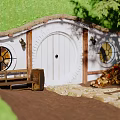 Cottage Entrance With Thatched Roof White Round Door Round Windows Bench And Stone Steps
