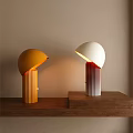 Orange And White Table Lamps With Hemispherical Shades Striped Bases On Wooden Table