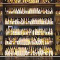 Modern Wine Cabinet with Multiple Shelves Displaying Various Wine and Liquor Bottles