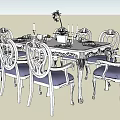 Elegant Dining Table Set With Carved Chairs Blue Cushions And Decorative Flowers