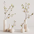 White Ceramic Vases Adorned With White Blossoms And Green Leaves On Light Background