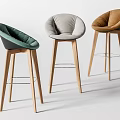 Three Modern Minimalist Bar Stools With Green Gray Brown Upholstered Seats And Wooden Legs