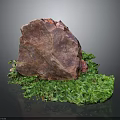 Red Natural Stone with Green Moss on Dark Background and Reflection Texture