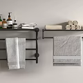 Gray Bath Towels Hanging On Black Racks With Rolled Towels And Toiletries