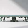 Artistic Outdoor Table With Light Blue Textured Tabletop And Root Like Green Legs