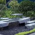 Water Fountain Garden With Stone Steps Green Plants And Flowing Water