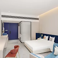 Hotel Guest Room With City View Blue Sofa Red Chair Round Mirror And Vanity
