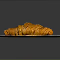 Golden Croissant On White Plate With Orange Croissant Patterns