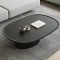 Modern Black Oval Coffee Table With Gray Sofa On Rug And Decorative Book
