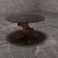 Black Round Top Side Table With Wooden Cross Base On Gray Marble Floor