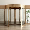 Modern Bronze Revolving Door With Glass Panels And Indoor Plant