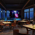 Modern Bar Interior With Open Counter Green Plant Wall And Night View Windows