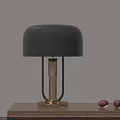 Black Table Lamp With Gold Base And Metal Stand On Wooden Tabletop With Red Fruits