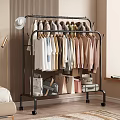 Various Colorful Clothes Hanging On Metal Clothes Rack With Bags And Suitcases In Bedroom Corner