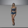 Woman in blue tank top and denim shorts standing against gray background