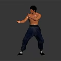 Man Performing Martial Arts Action In Black Vest And Blue Pants Against Gray Background