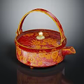 Red And Gold Patterned Teapot With Curved Handle And Decorative Lid Knob