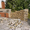 Outdoor Brick Grill Area With Chimney Firewood Stack Stone Paved Ground And Green Trees