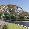 Wooden Arched Entrance Gate With Surrounding Trees And Water Area Under Blue Sky