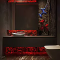 Modern Artistic Dark Tone Bathroom With Creative Decor Vessel Sink And Warm Red Ambient Lighting