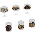 Assorted Cookies And Pastries Displayed In Glass Domes And Jars With Lids