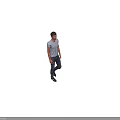 A Man Walking Wearing Light Blue T-Shirt and Dark Jeans Casual Outfit