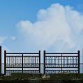 Wooden Fence With Decorative Patterns Under Blue Sky And White Clouds By Water And Grass