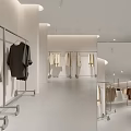 Minimalist Clothing Store Interior With White Walls Light Floor Clothing Racks And Hanging Clothes