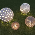 Decorative Spherical Outdoor Lights With Hollow Patterns And Woven Texture Illuminating Grass Area