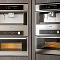 Modern Built in Kitchen Appliances With Double Stacked Ovens Coffee Machines Cabinetry And Interior Lighting