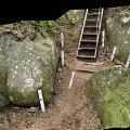 Metal Staircase In Natural Setting With Rock Walls Green Plants And Dirt Ground