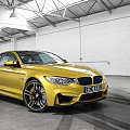 Yellow BMW M4 Coupe Parked In Garage Featuring White Brick Walls High Ceiling Tire Tracks