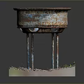 Old Rusty Metal Basin With Four Legs And Gravel Weeds Around Base