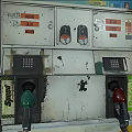 Public Fuel Station Facility With Old Fuel Pumps And Advertisement Billboards